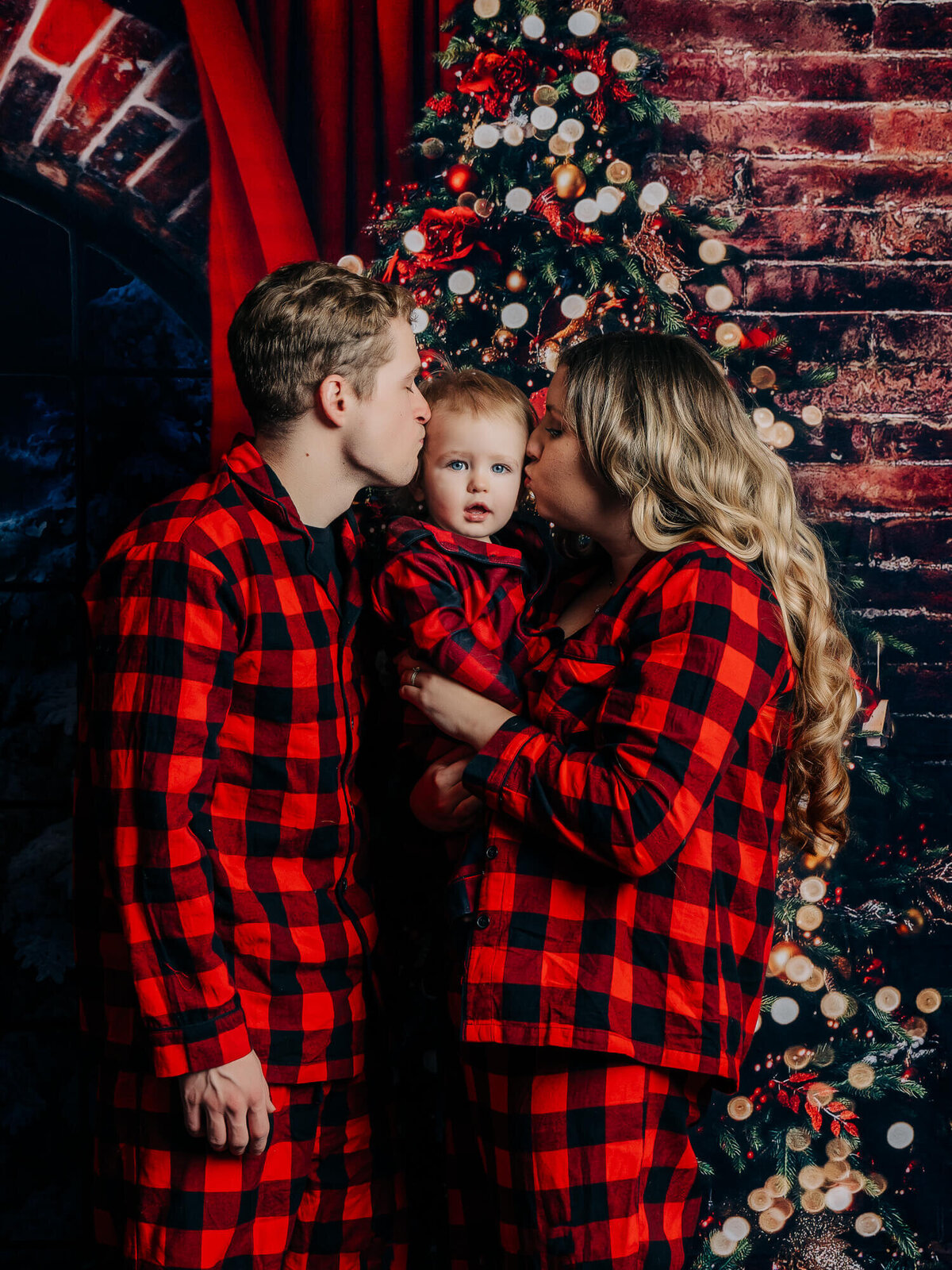 Parents kiss little boy in holiday Prescott family photography session