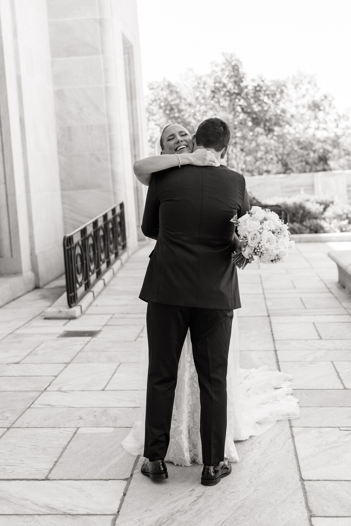 Bride and groom hug after first look, smiling in joy; sweet moment captured by Philadelphia wedding photographer.