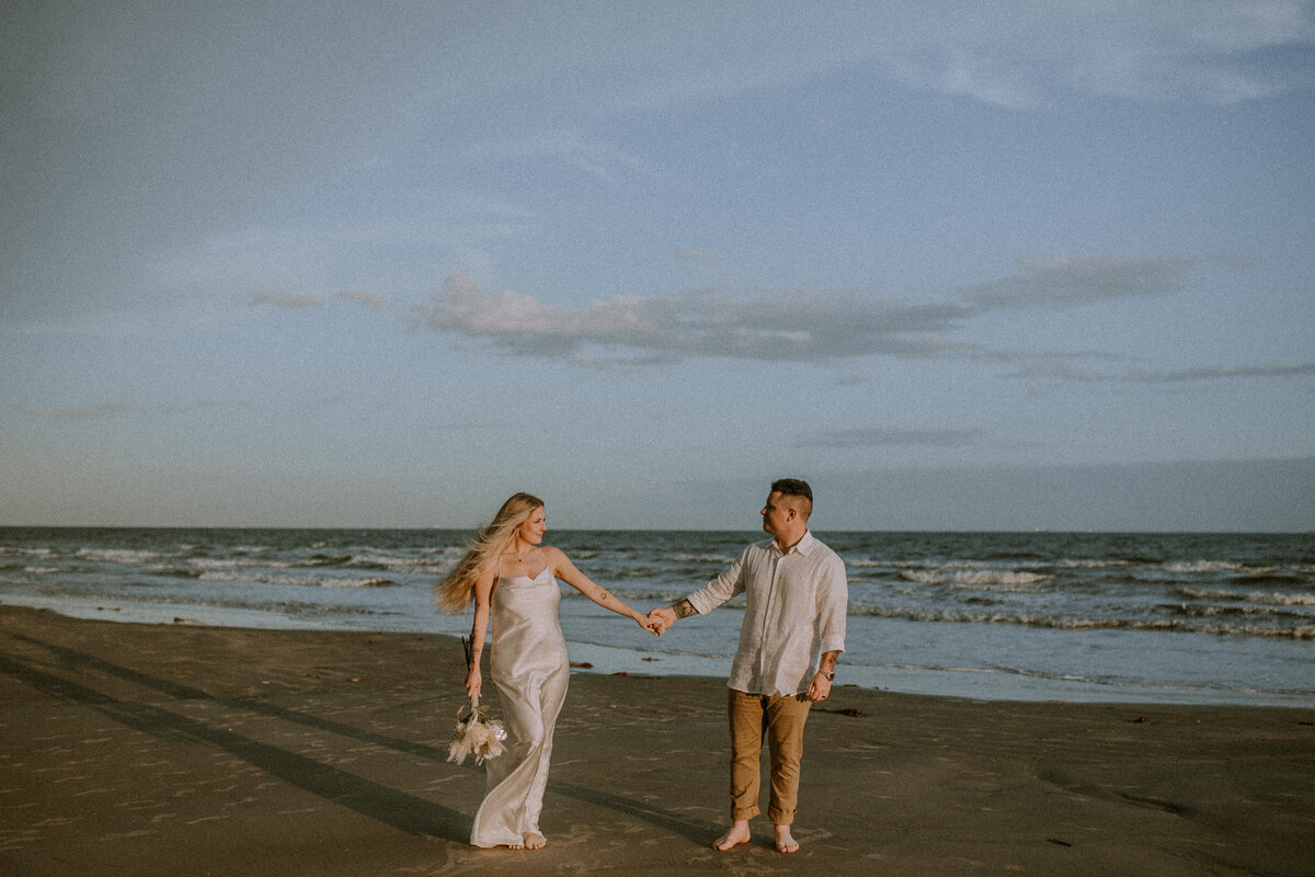 As a wedding photographer documenting an elopement on Galveston's shores, I was swept away by the beauty and intimacy of the couple's beachside ceremony. With the salty sea breeze caressing their faces and the golden sun casting a warm glow, every photograph captured the essence of their love and the natural splendor of their surroundings.