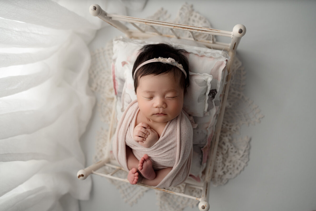 Lansing Newborn Photography Baby wrapped in bed By For The Love Of Photography