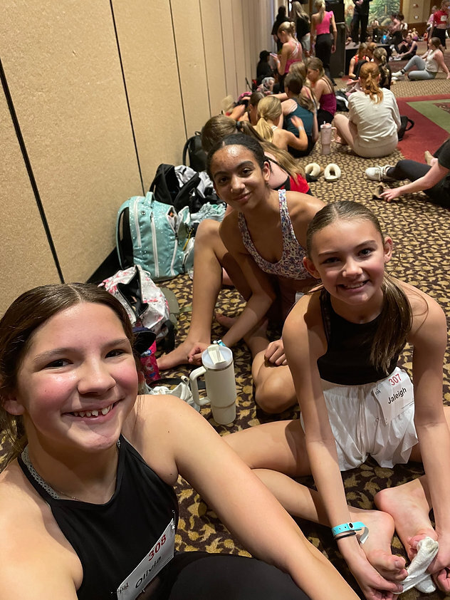 a few middle school girls stretching at convention