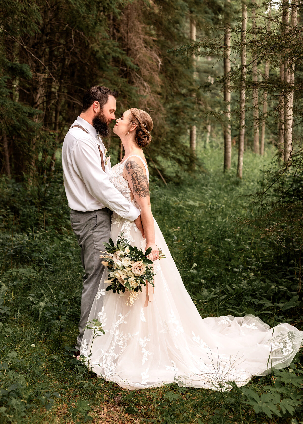 Bride and groom go nose to nose during portrait