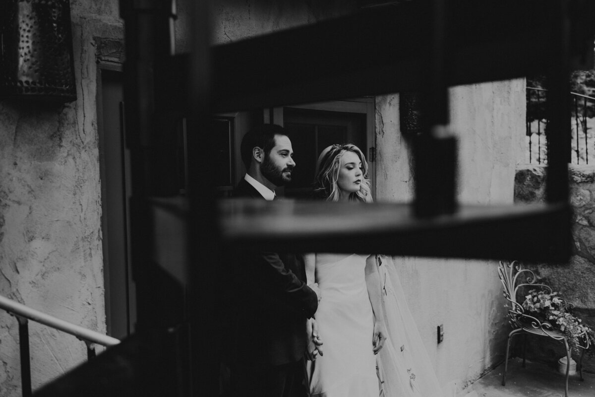 photo of a bride and groom together through a spiral staircase