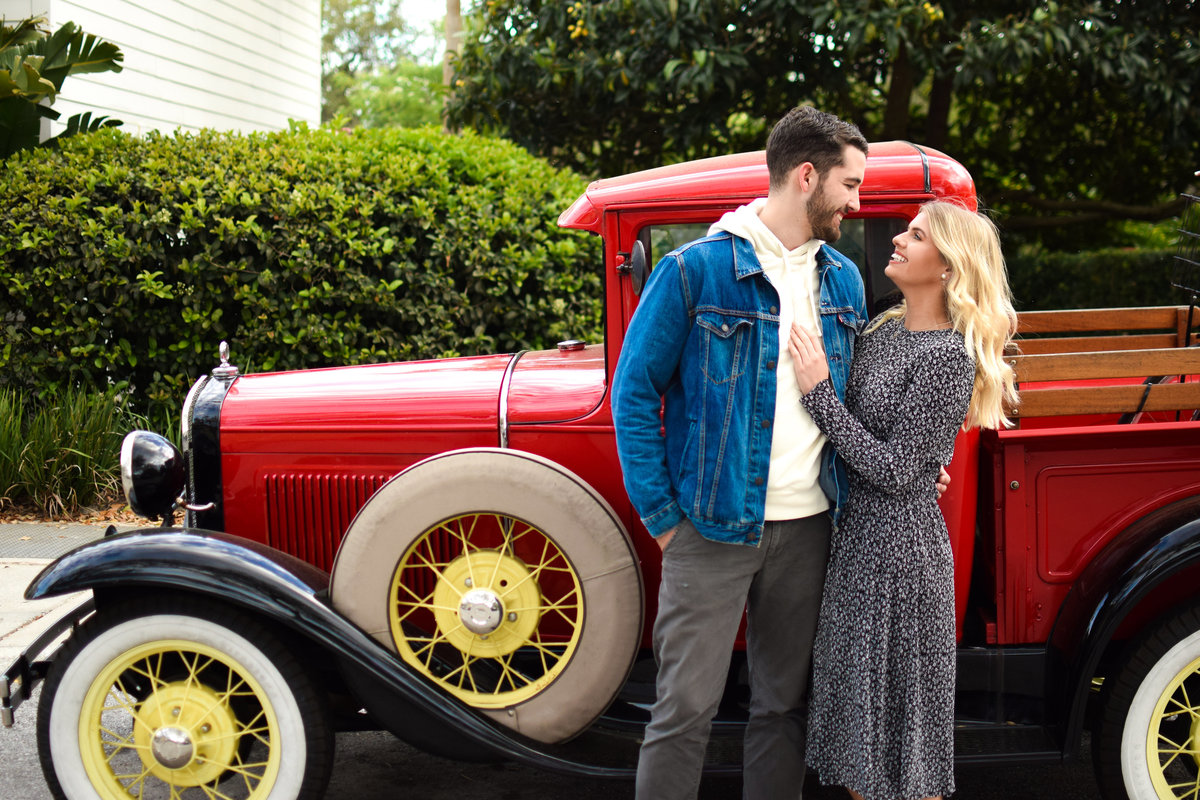 Couple with vintage red truck Celebration Florida