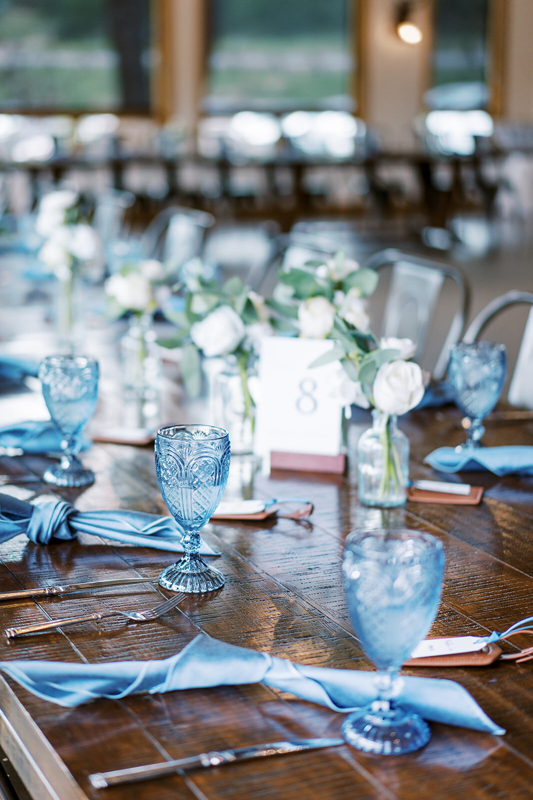 Light blue  water goblets,  napkins, and white flowers for a reception setup at the Landing in Estes Park.