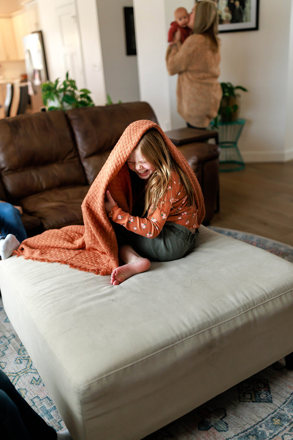 girl-giggling-on-ottoman