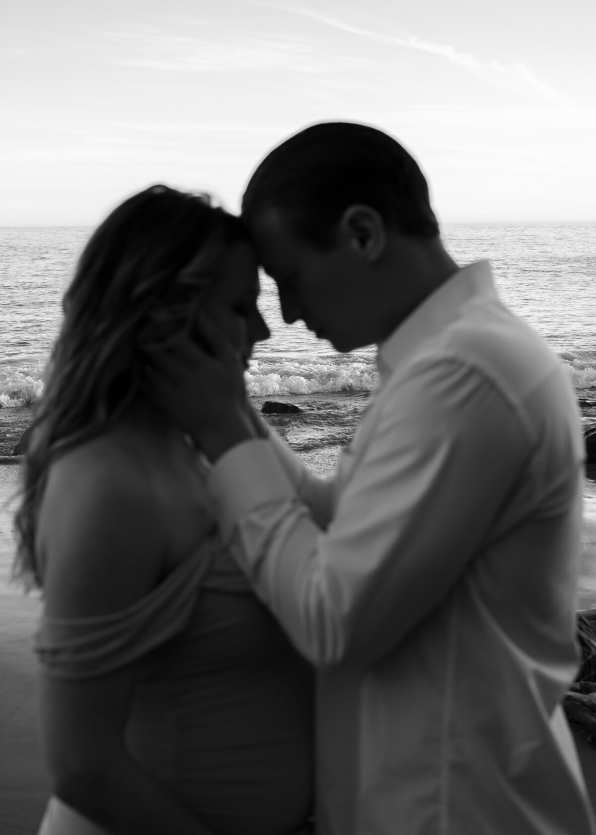 moody black and white maternity beach photo