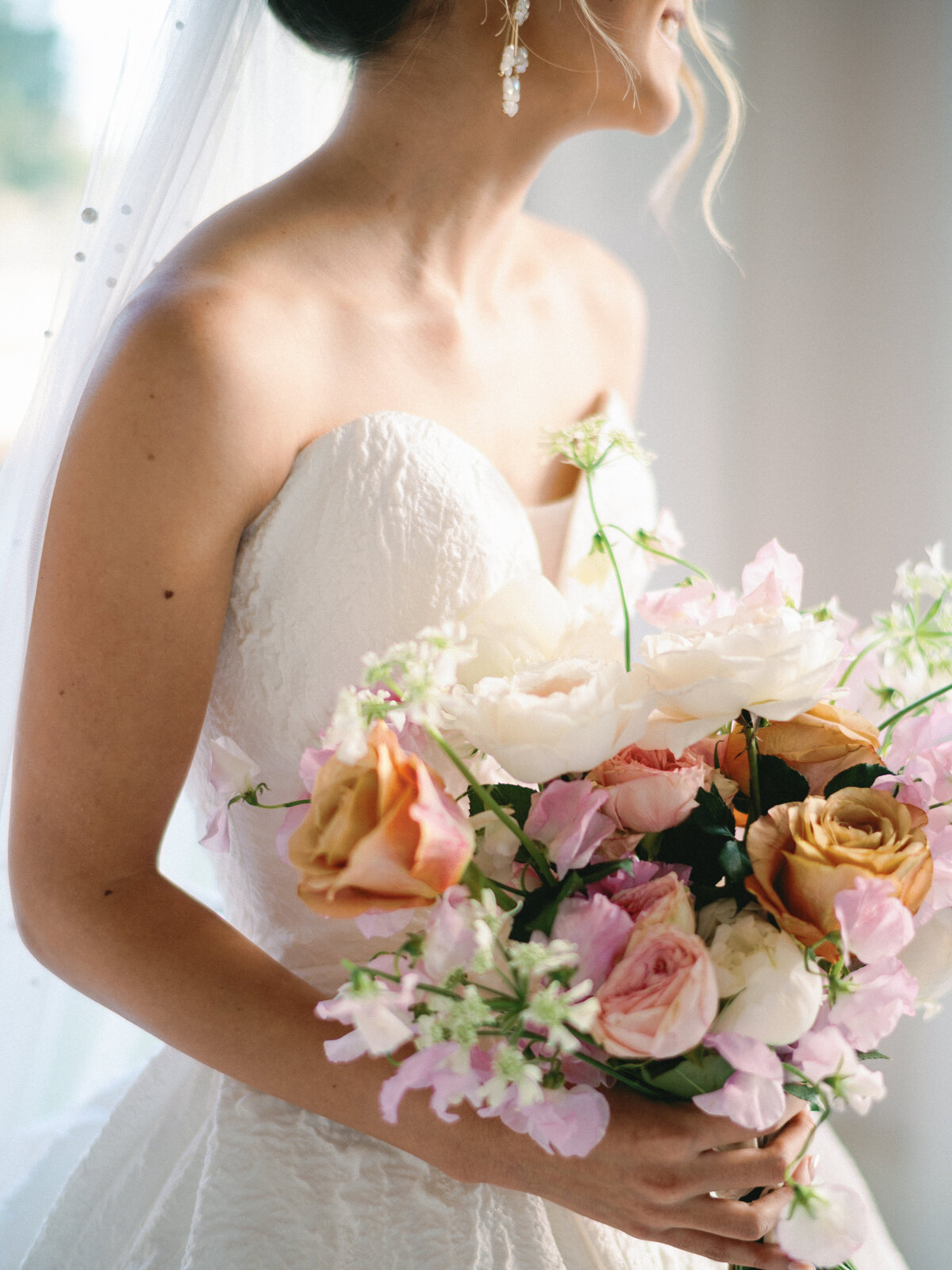 Bridal bouquet with pink, orange, and white flowers