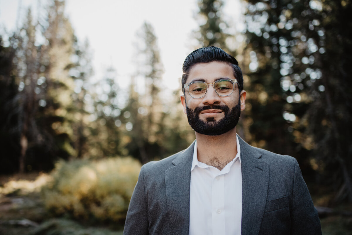 photographers in jackson hole photographsman in Jackson Hole in a suit and fancy glasses with a nice hair  and a beard