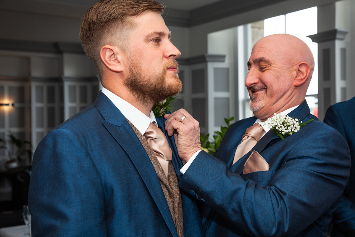 pro-story-photography_proud-father-adjusting-groom-button-hole_duke-of-cornwall-hotel_plymouth