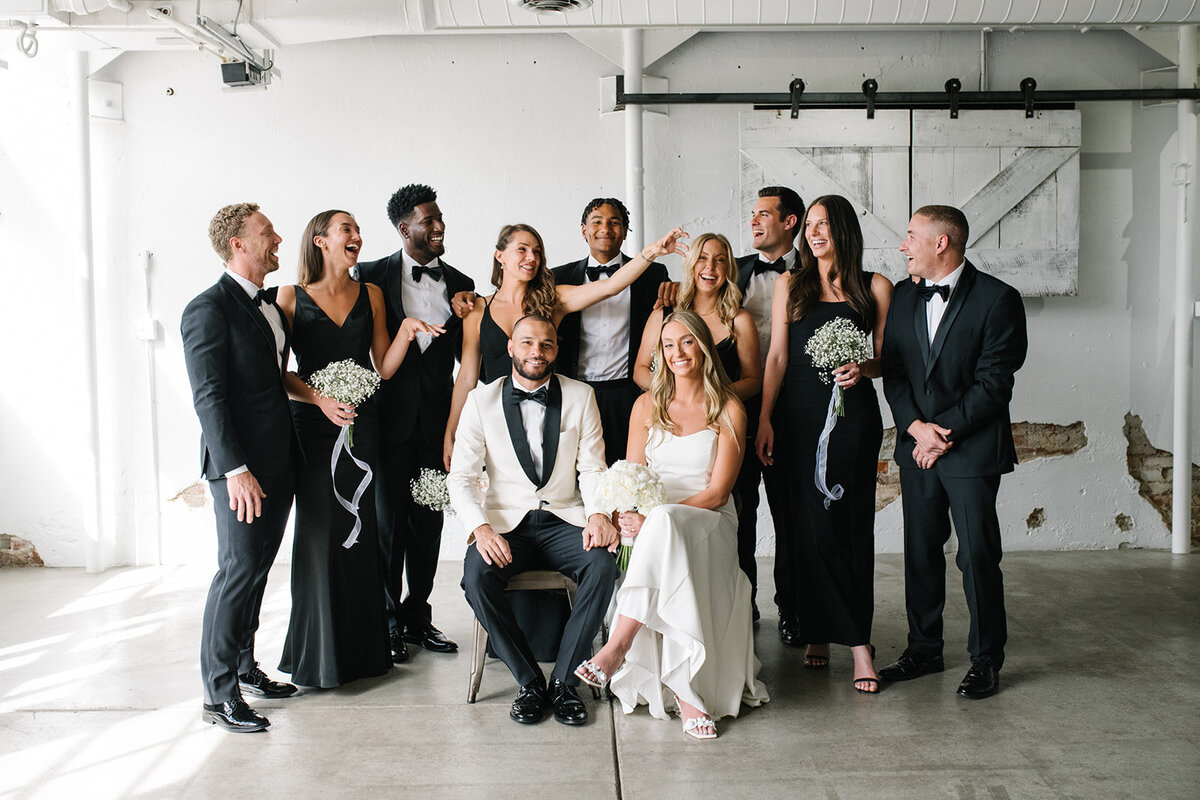 Guests laughing during a heartfelt toast at a Denver wedding reception, captured in an unposed, documentary style.