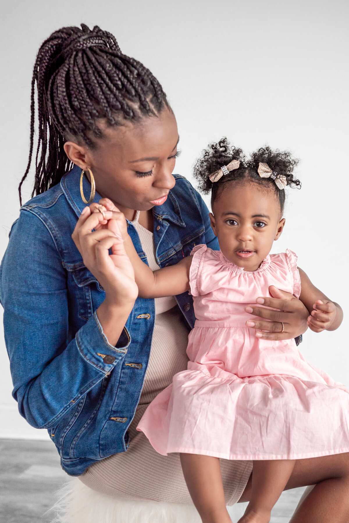 A mother holds her daughter for family pictures in a studio in Huntsville Alabama