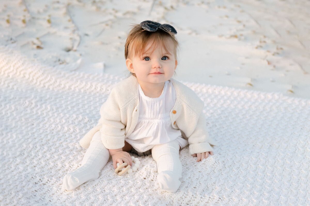 little girl posing for destin family photographer at the beach