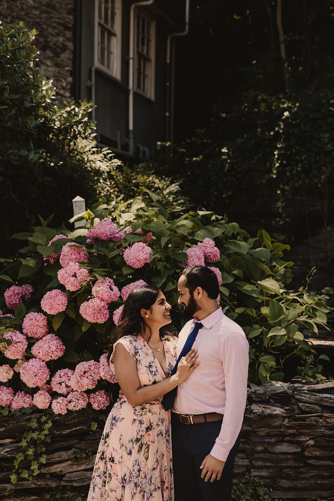 A person smiling at their partner as they rest their hand on their chest 