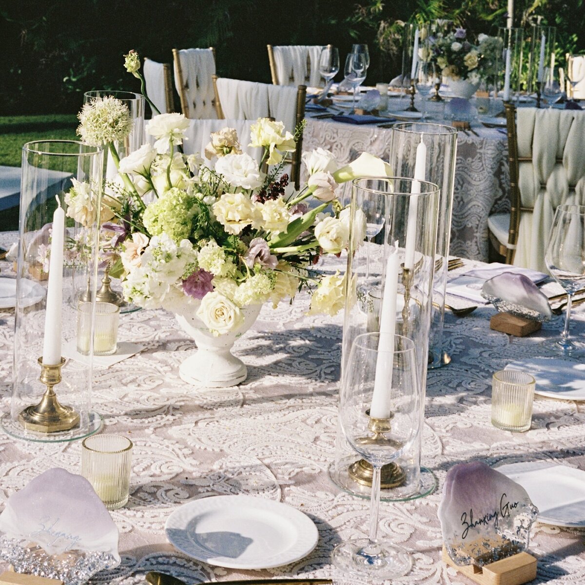 A refined tropical wedding tablescape on Oʻahu, captured on film with soft light, lush florals, and natural textures by Kate Winters Photography