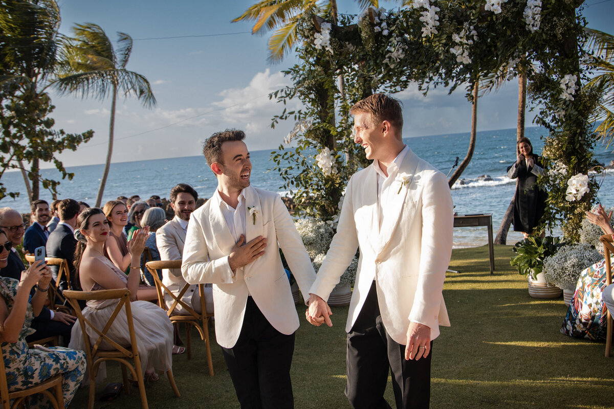 A couple walks hand and hand  at a destination wedding in Puerto Rico
