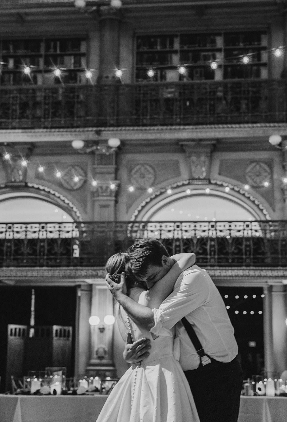A wedding couple hugging tightly 