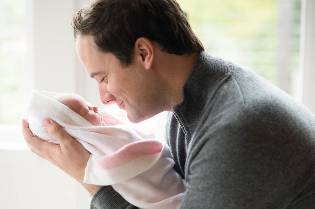 dad holding new baby girl
