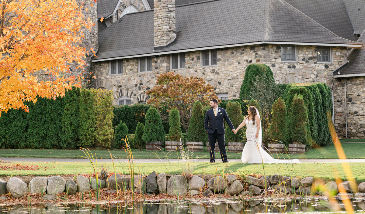 a couple walking by a castle at their destination wedding
