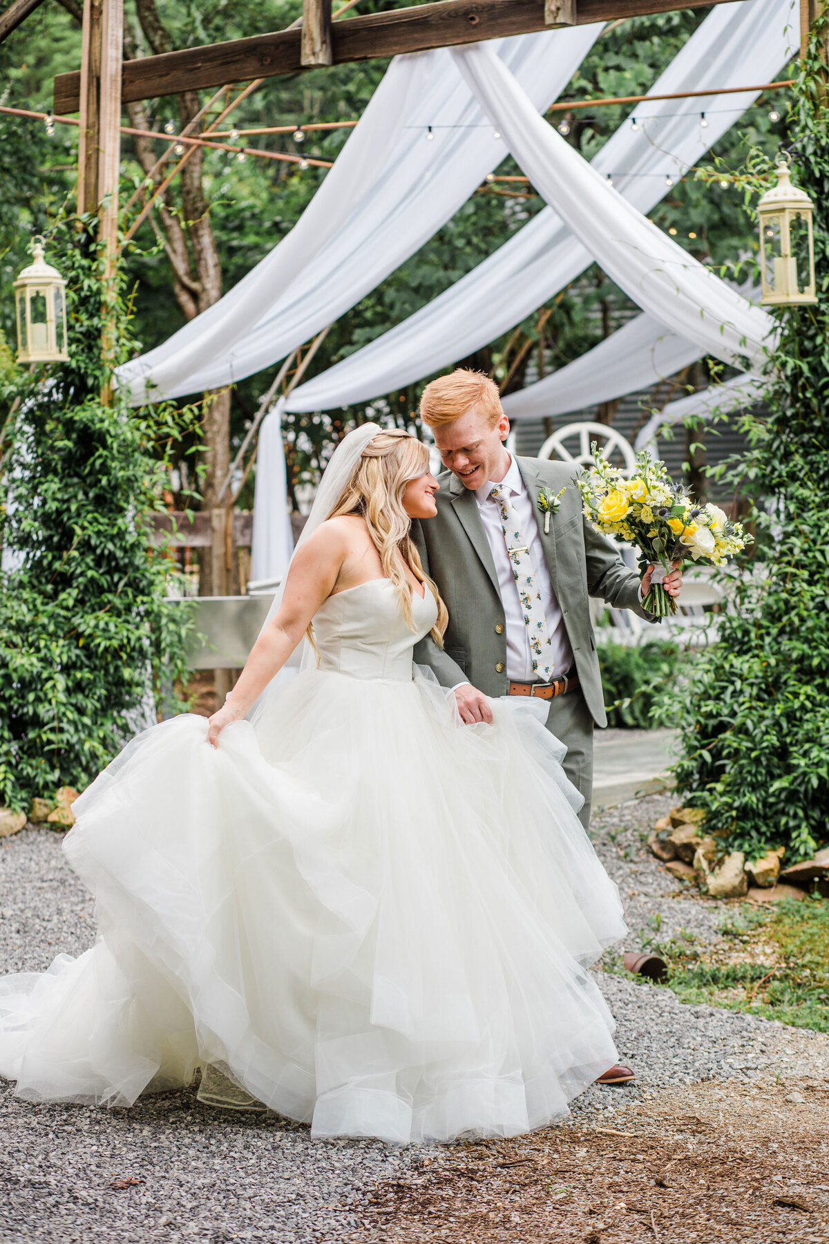 bride and groom walking together at summer wedding