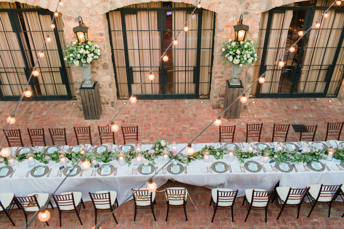 A breathtaking aerial shot of an outdoor wedding reception at the Silverleaf Club in Scottsdale, AZ, showcasing elegant decor and twinkling lights.
