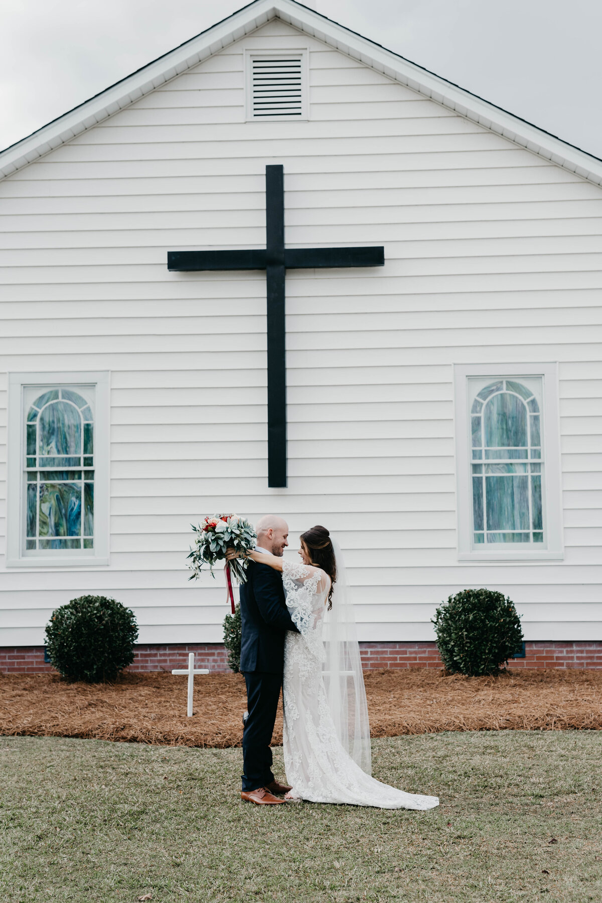 Bride and groom in front of a church