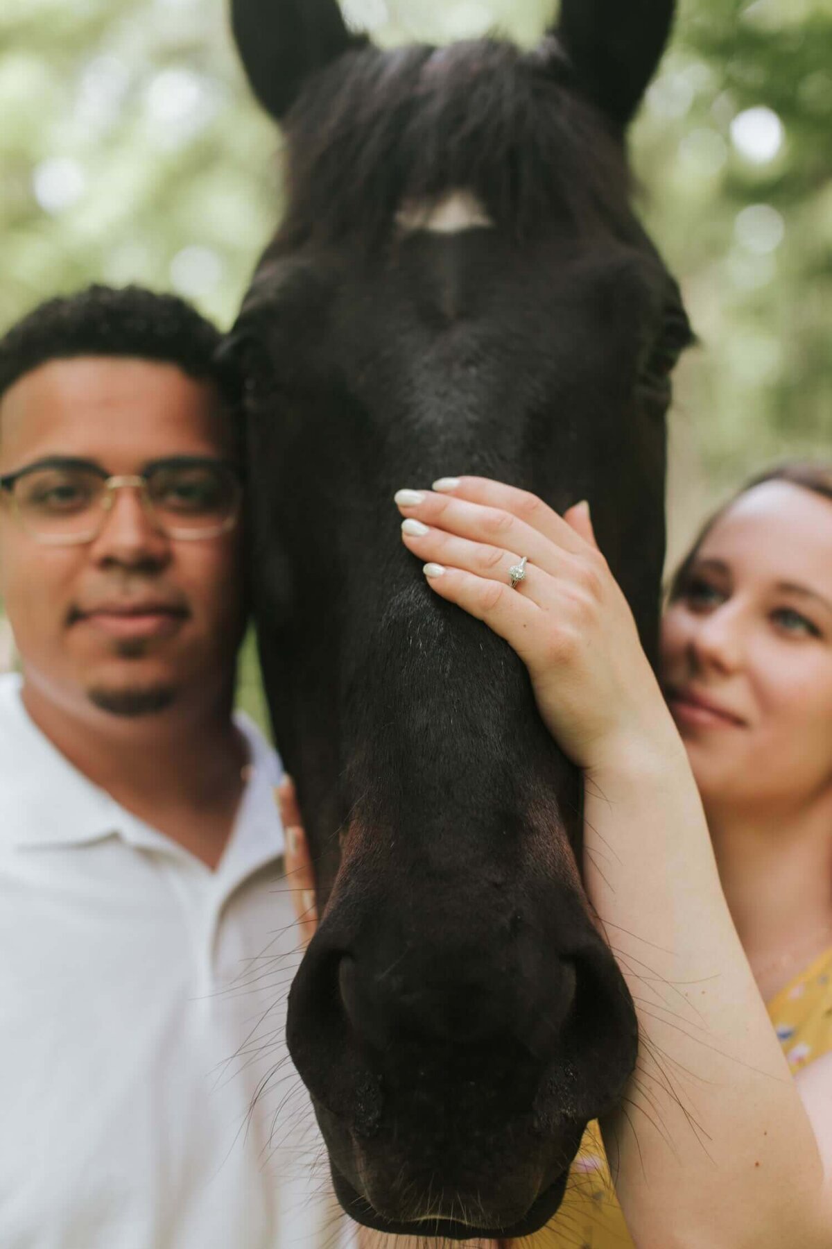 Bride and groom with their horse during portraits.