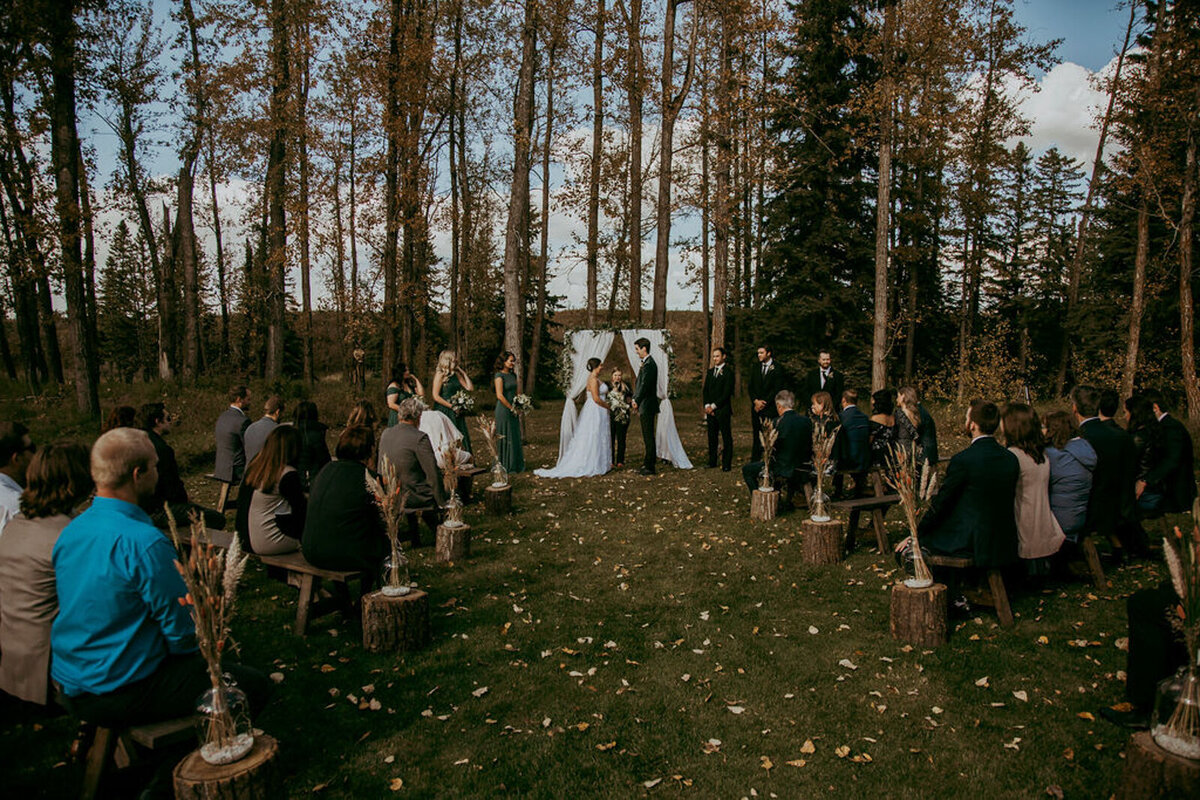 Stunning outdoor Fall wedding ceremony at 52 North Venue, an industrial and unique wedding venue in Sylvan Lake, AB, featured on the Brontë Bride Vendor Guide.52 North Venue, an industrial and unique wedding venue in Sylvan Lake, AB, featured on the Brontë Bride Vendor Guide.
