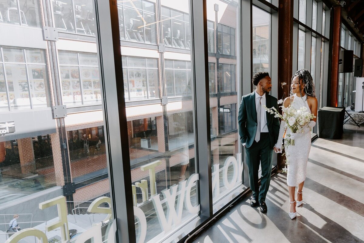 Bride and groom walking on a glass wall