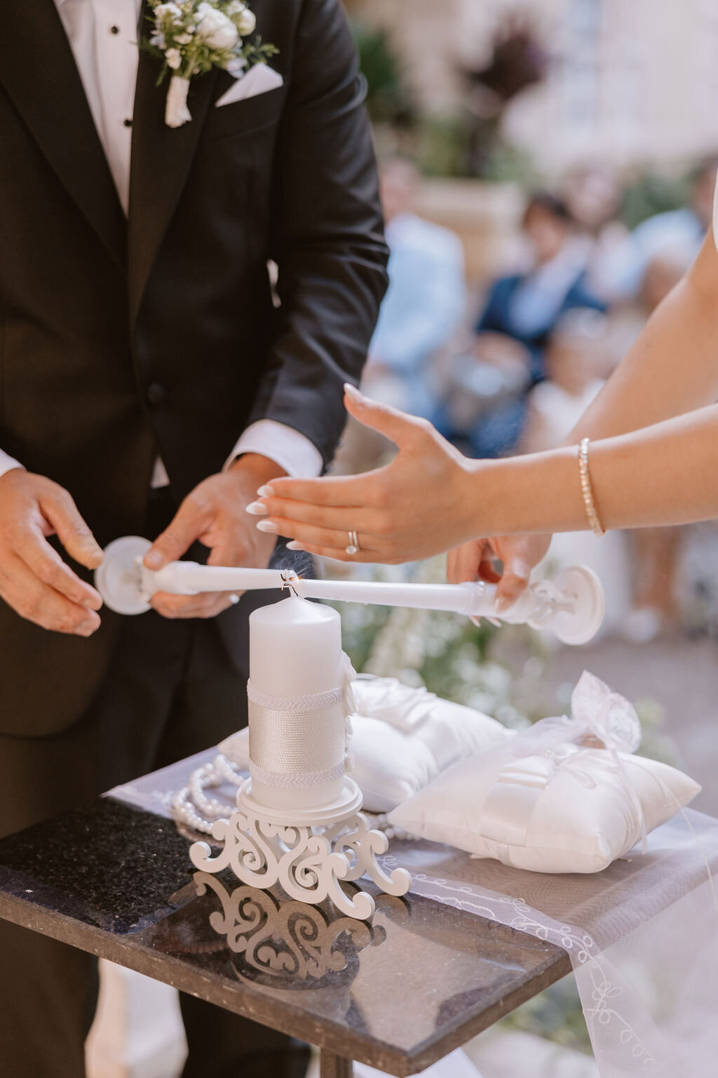 bride and groom lighting candle for religious ceremony