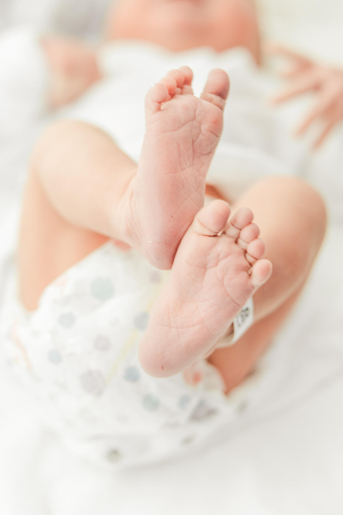 Close up photo of a newborn's tiny feet and beautiful new-born's skin. Captured in Rockhampton Base Hospital by Julie-Anne Photography.