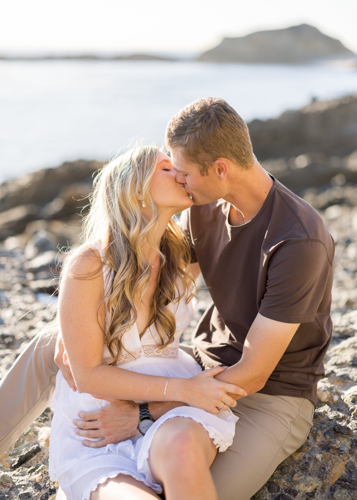 romantic kissing engagement photo on the beach