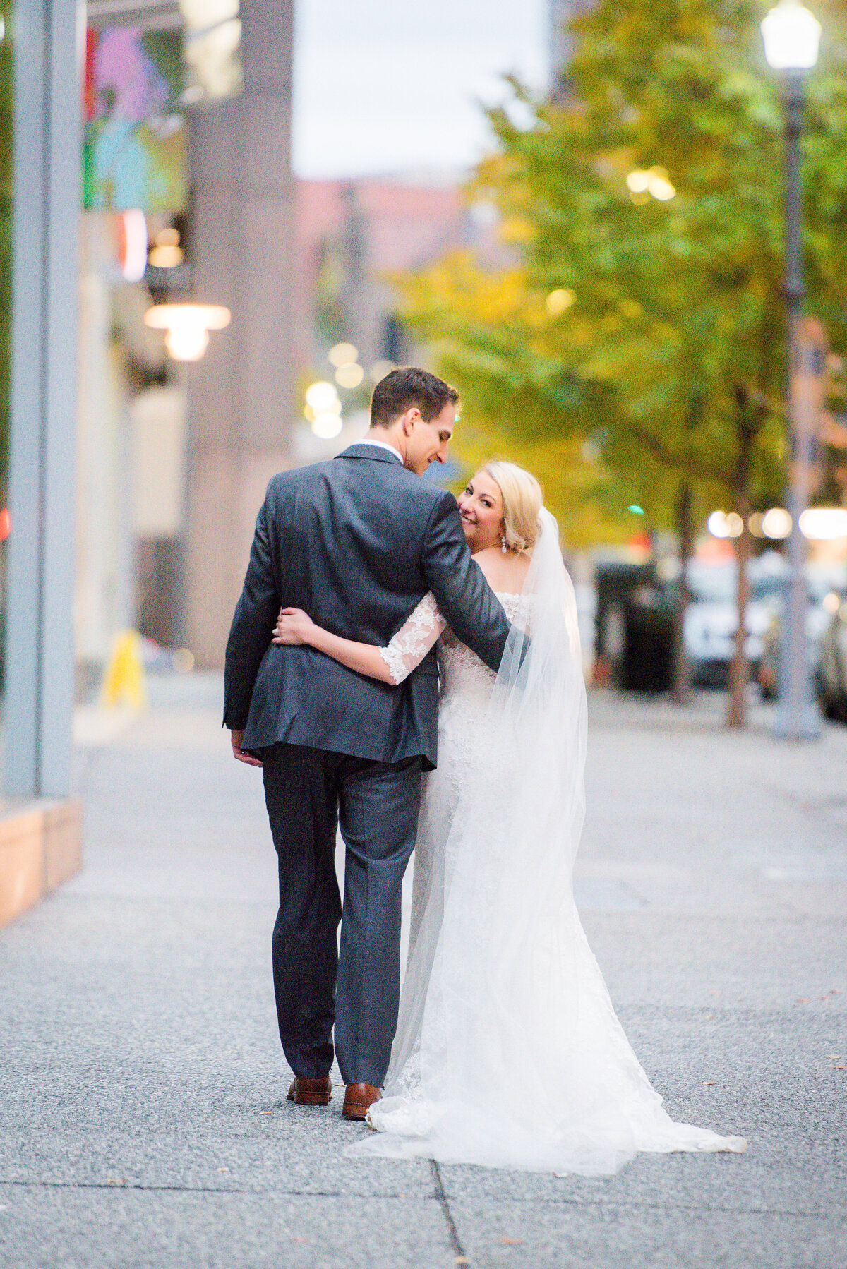 bride and groom posing for wedding photo on the street outside of the fairmont hotel pittsburgh