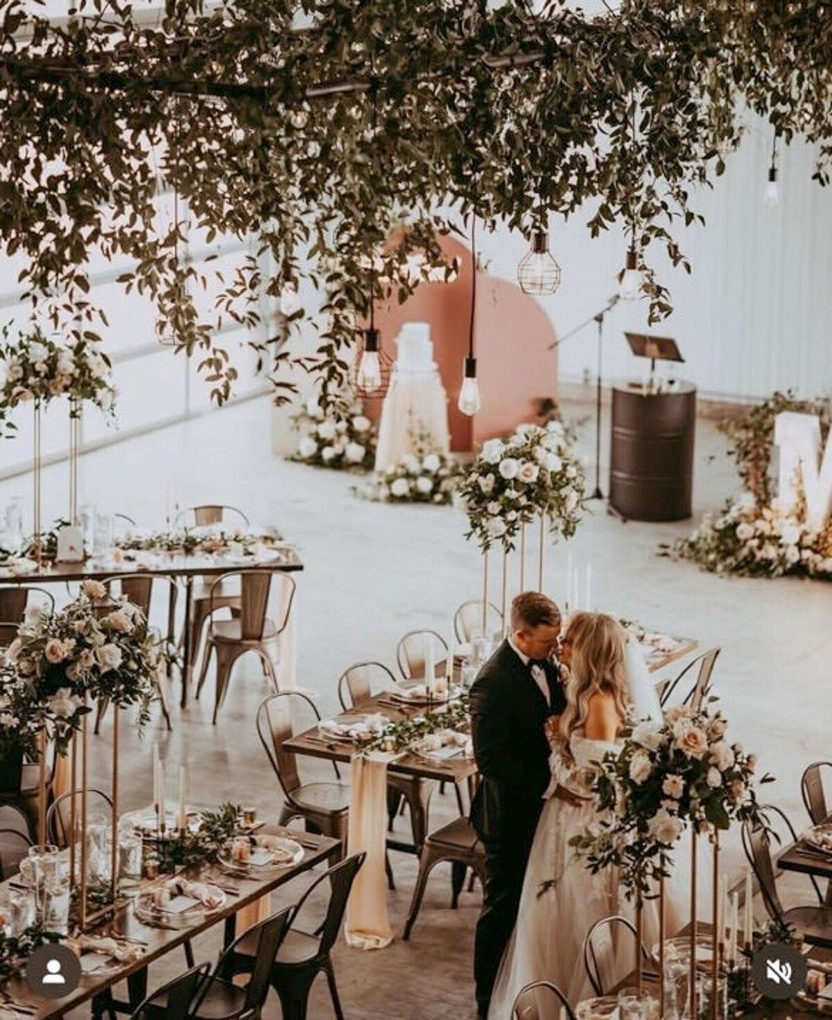 Stunning reception hanging floral installation by Calyx Floral Design, an innovative Red Deer, Alberta wedding florist, featured on the Brontë Bride Vendor Guide.