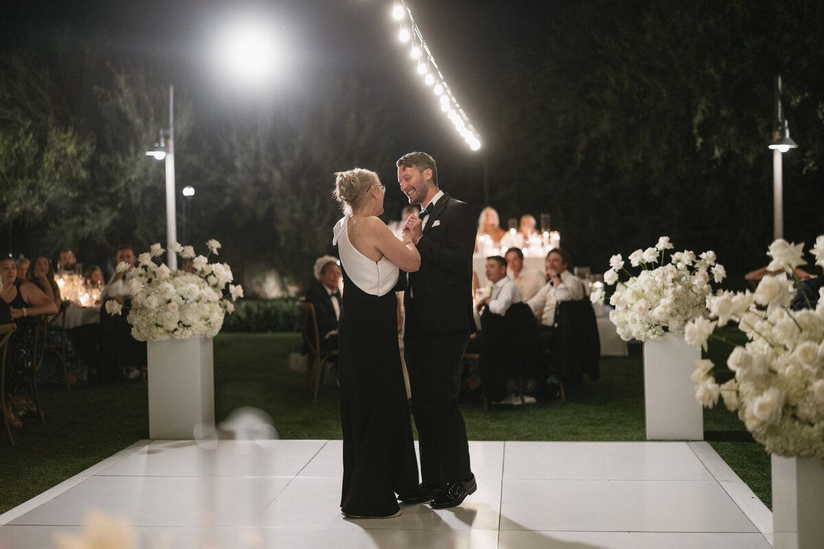 Groom and his mom sharing a dance during wedding reception