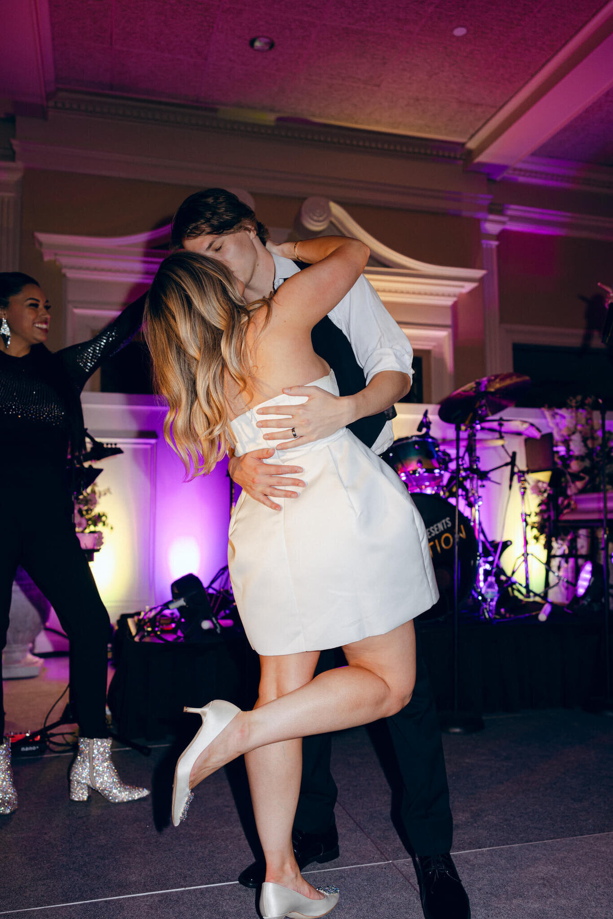A wedding photo oft he bride and groom dancing during the wedding reception