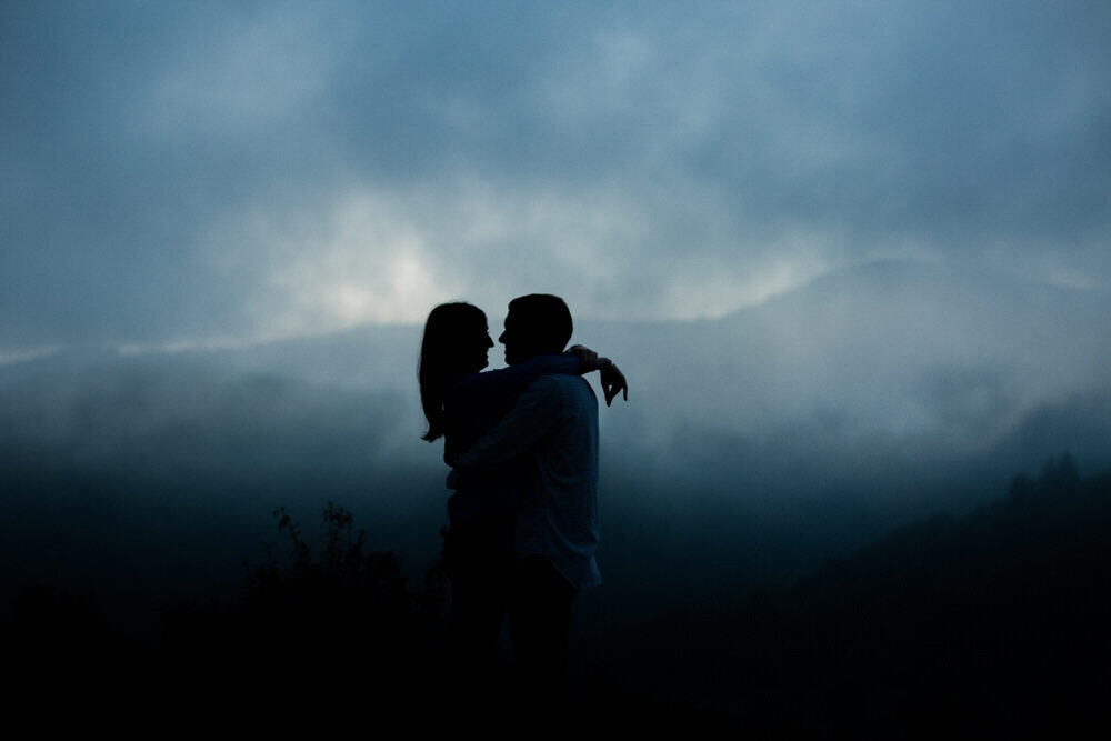 silouette of a couple embracing during their foggy blue ridge parkway engagement session