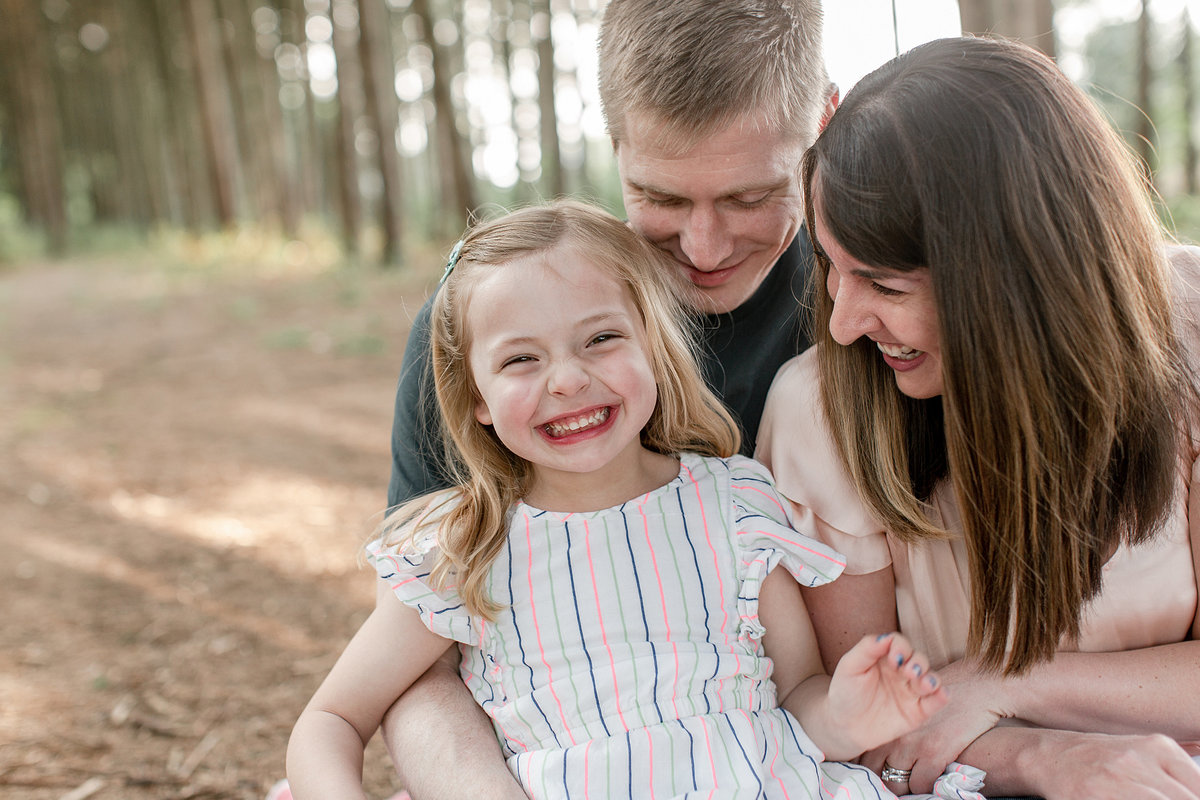 Laughing family in genuine outdoor pose