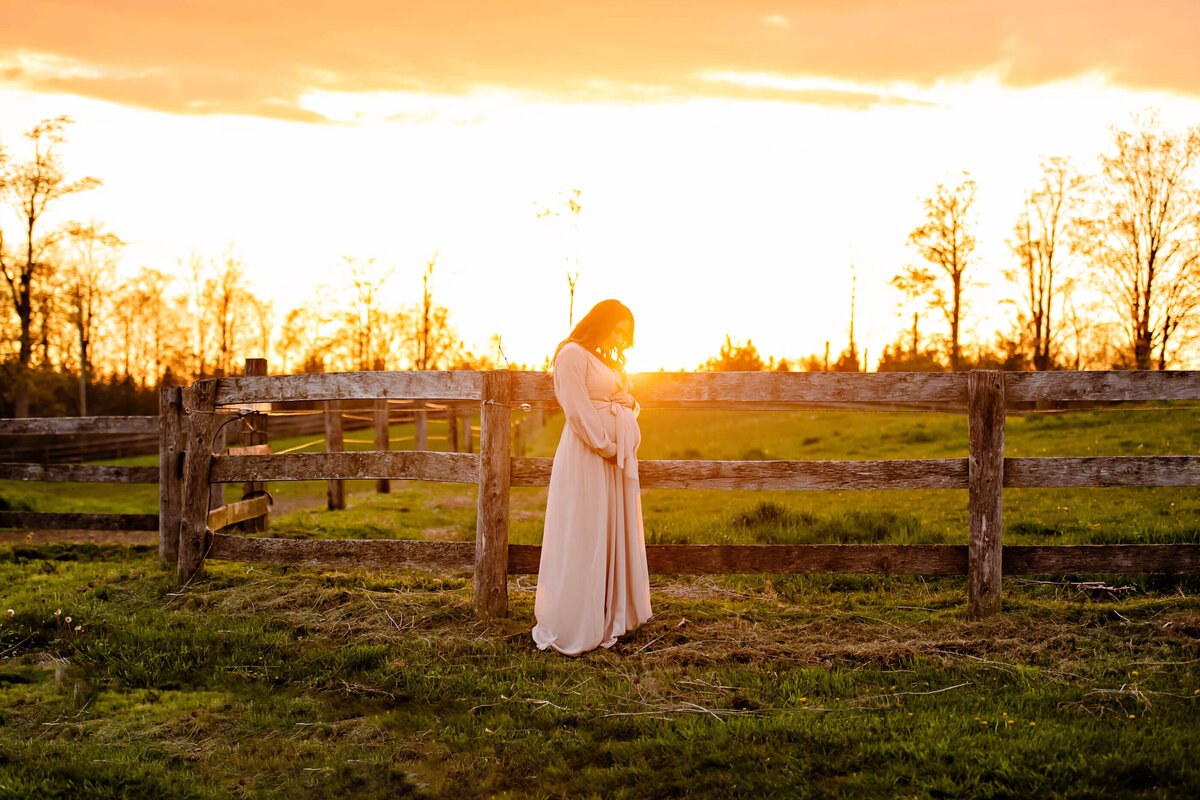 pregnant woman basking in the golden hour light for her maternity photos