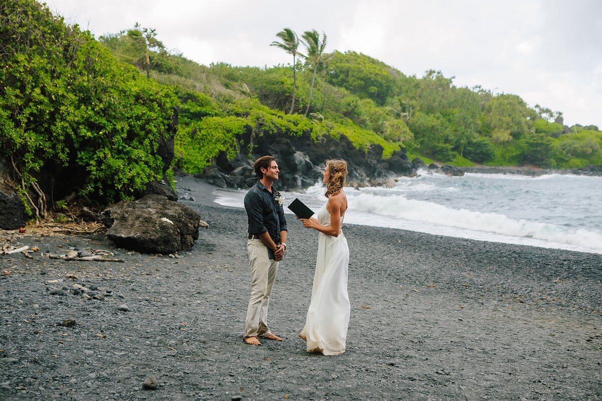 A bride and groom read their vows during their elopement ceremony in Hawaii