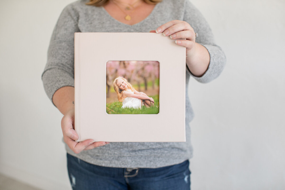 Tiffany Hix holding a photo album.