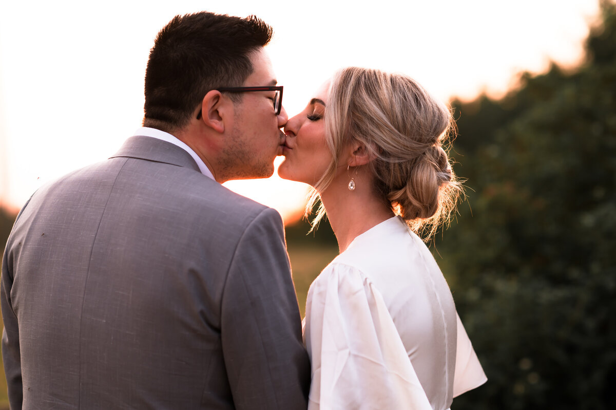 couple shares a kiss during engagement portrait session