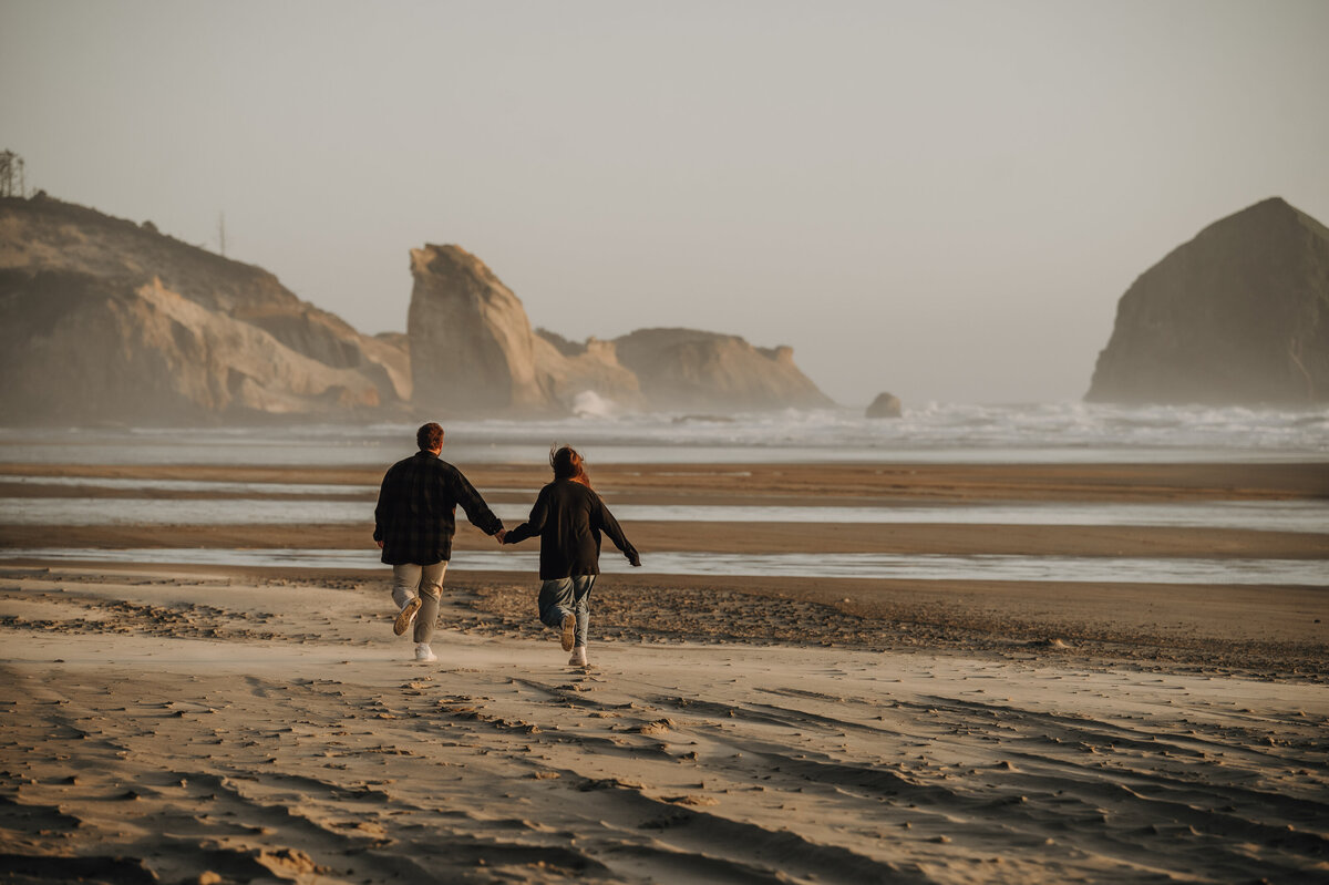 Photo of Alberta couple walking down sandy beach 