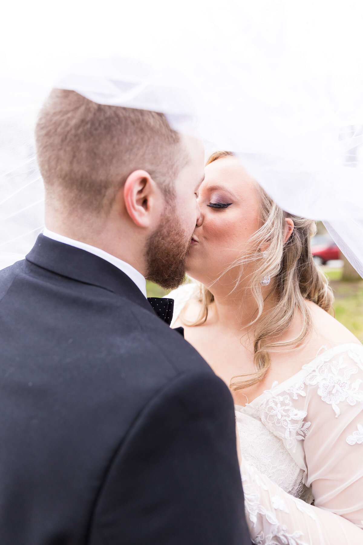 bride and groom kissing under the veil at  The Gatsby in Shelbyville,KY