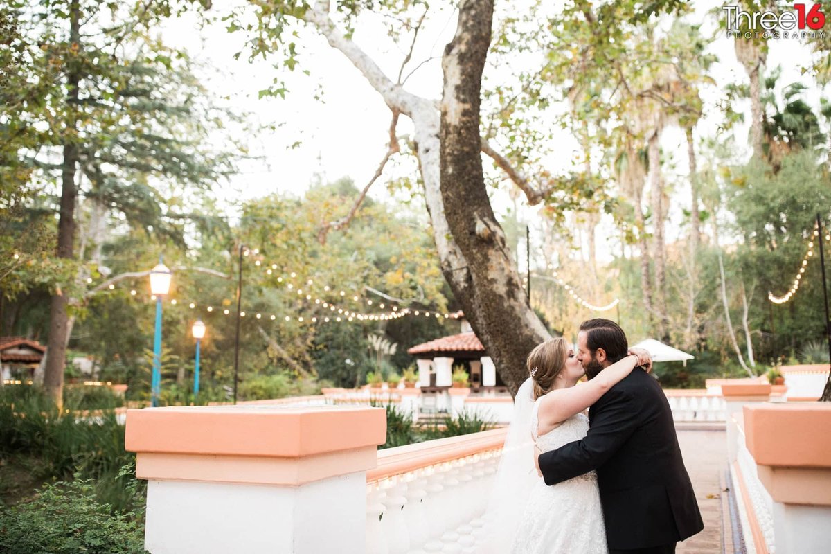 Bride and Groom share a kiss on the grounds of Rancho Las Lomas