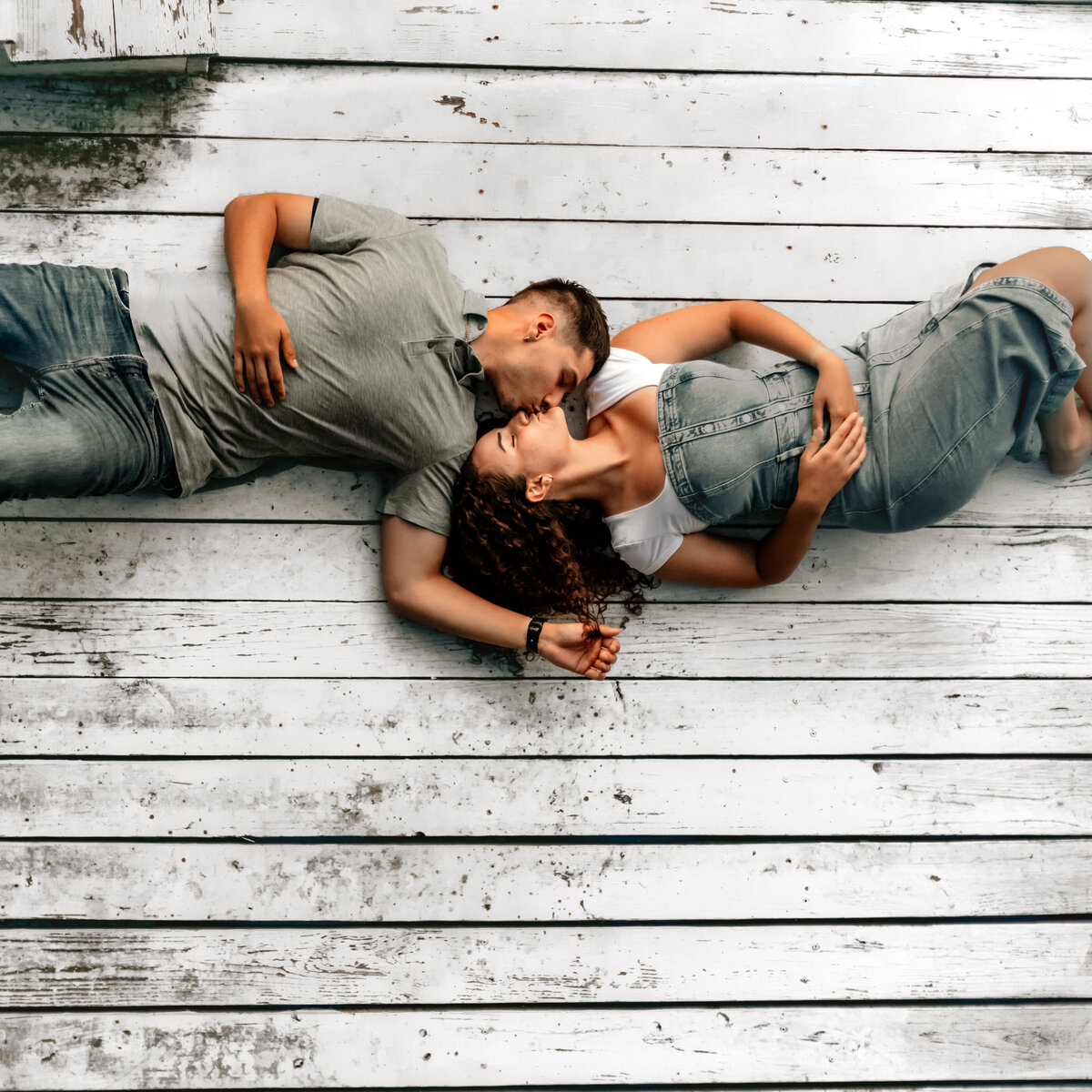 Salem VA wedding and Elopement photographer earthy and moody Charleigh Roberts Photography artsy earthy moody virginia roanoke va east coast enagagment session couples dock water lake candid denim laying on the dock drone shot