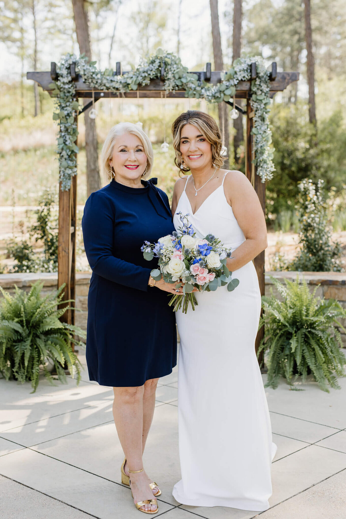 mother of the bride standing by bride after Longview, TX elopement ceremony