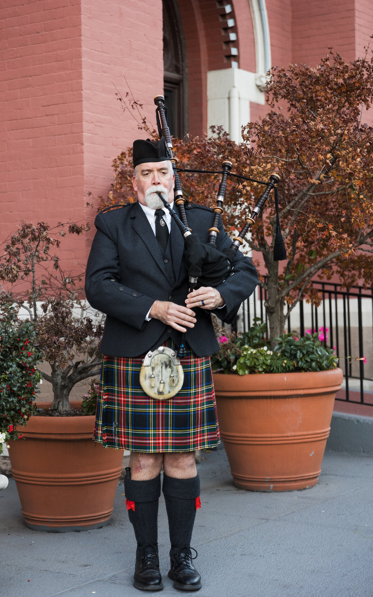 Scottish bag-piper playing during church entrance.