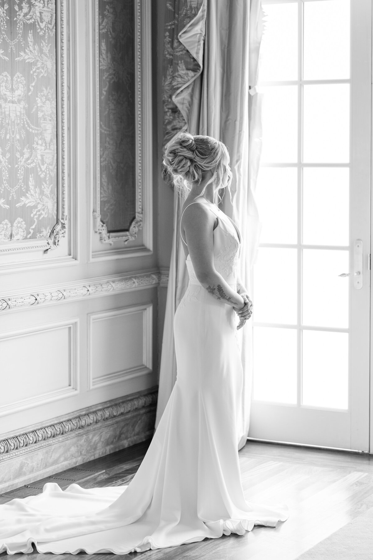 black-and-white-bridal-portrait-of-bride-looking-out-window-from-inside-a-gorgeous-room