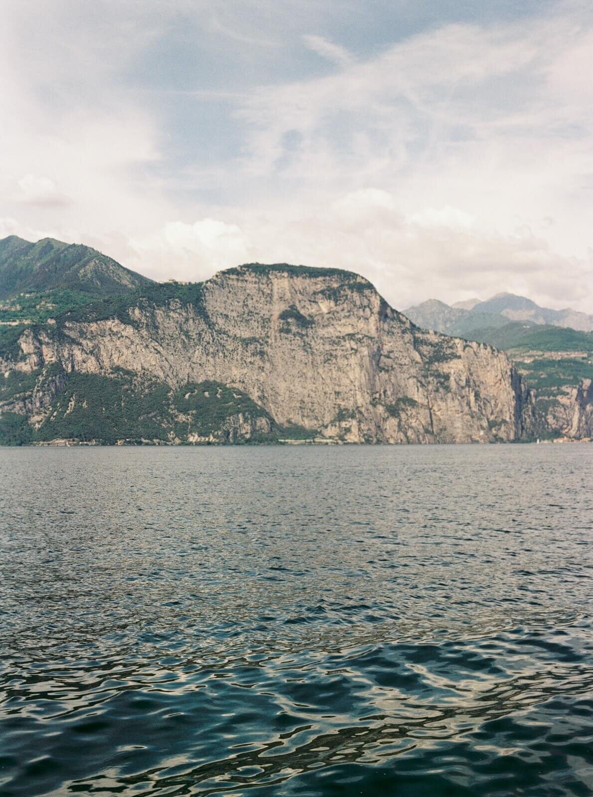 A photo of the cliffs on lake como in Italy taken from a boat